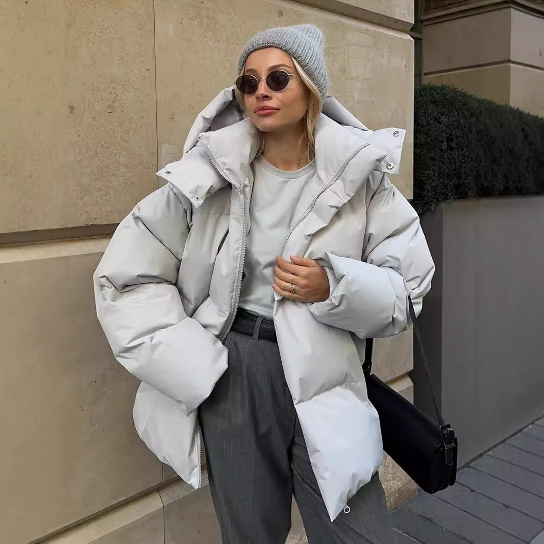 Woman wearing a gray puffer jacket from Langry, stylish ملابس for chilly weather