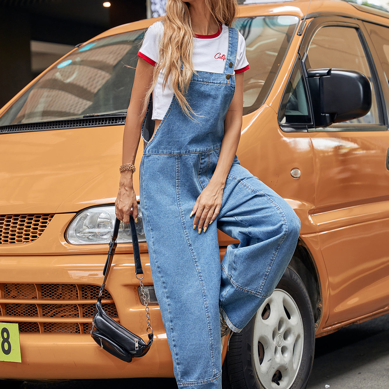 Denim overalls with a cropped t-shirt in a stylish casual denim jumpsuit for modern fashion