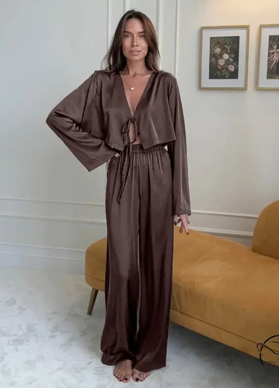 Woman in casual comfortable soft brown satin pajama set homewear