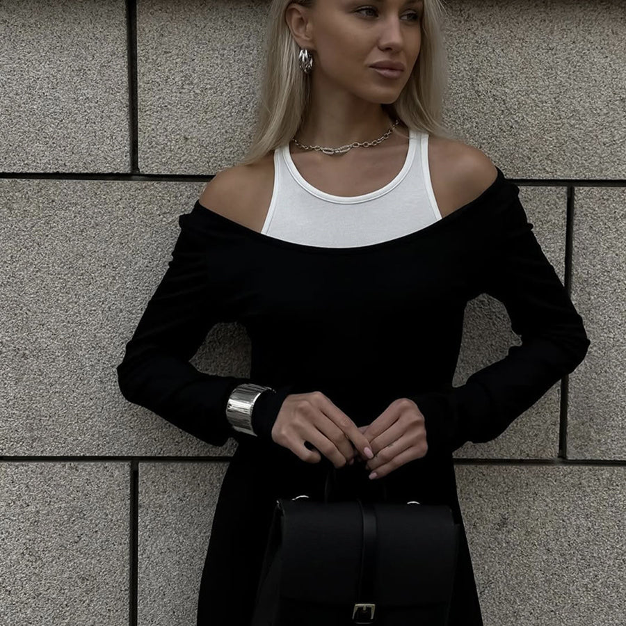 Stylish black and white cold-shoulder dress with a handbag, perfect for fashion enthusiasts