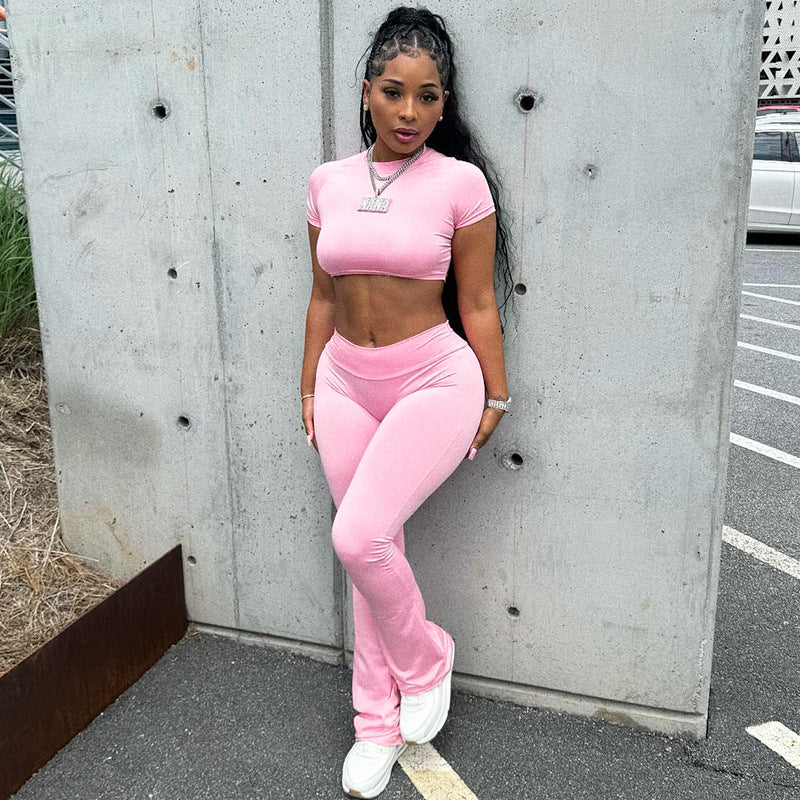 Woman in pink athletic wear modeling the SLIM FIT HIGH WAIST SUIT, a stylish high waist suit