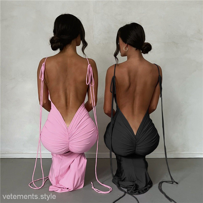 Two women wearing elegant slim fit sheath dresses with backless designs