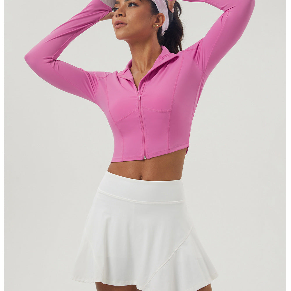 Long sleeve athletic crop top with zipper and tennis skirt, ideal for outdoor sports fashion