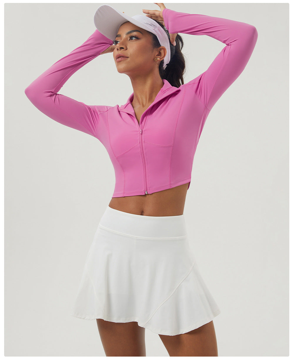 Long sleeve athletic crop top with zipper and tennis skirt, ideal for outdoor sports fashion