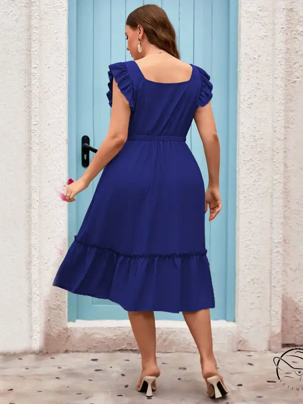 Woman in royal blue vacation casual midi dress with ruffles