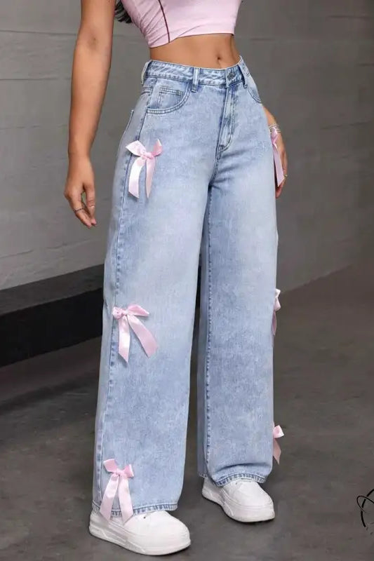 Light wash loose straight leg jeans with pink ribbon bows