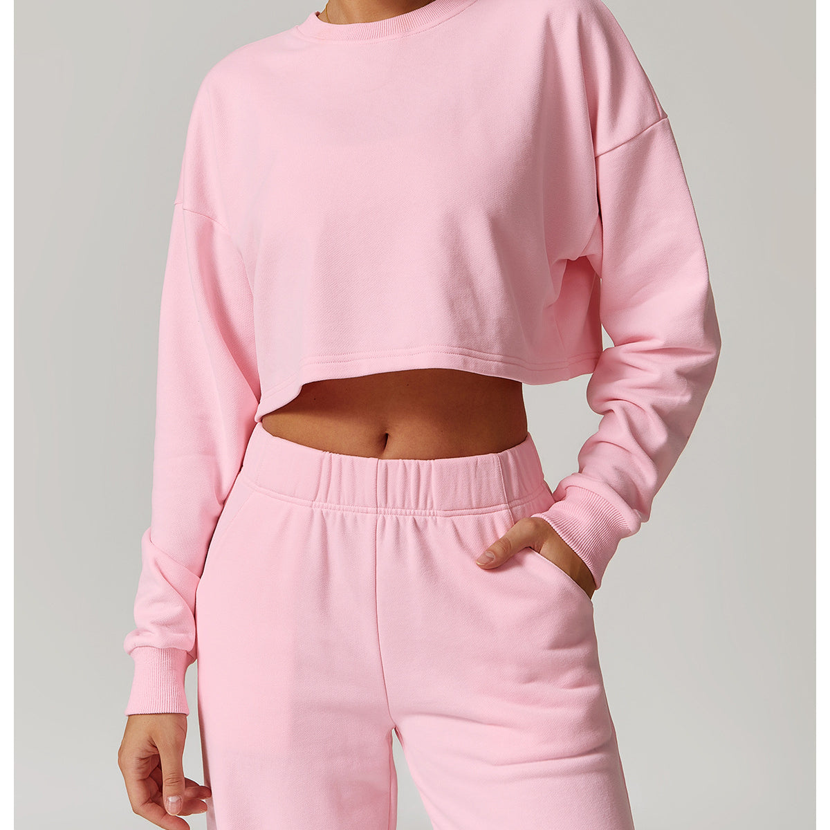 Pink cropped sweatshirt and sweatpants set for stylish long sleeve athleisure fashion