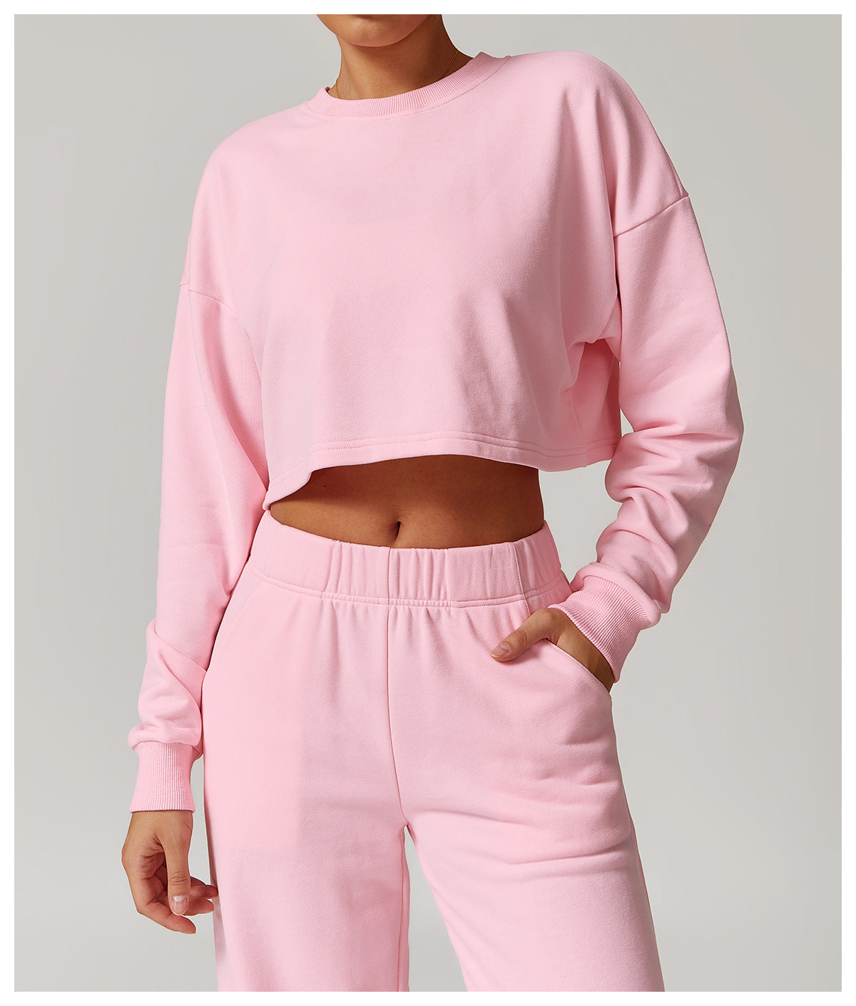 Pink cropped sweatshirt and sweatpants set for stylish long sleeve athleisure fashion