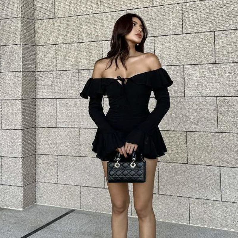 Woman in off-the-shoulder black dress showcasing elegant fashion and stylish ملابس
