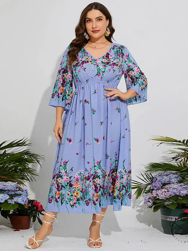 Woman in floral chiffon spring dress with elastic waist and bell sleeves