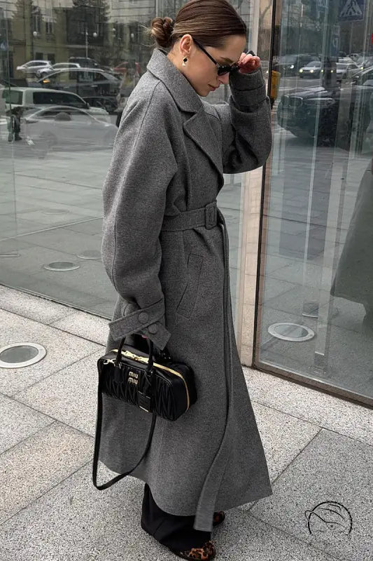 Black quilted Miu Miu handbag with gold-tone hardware in Langry fashion woolen coat