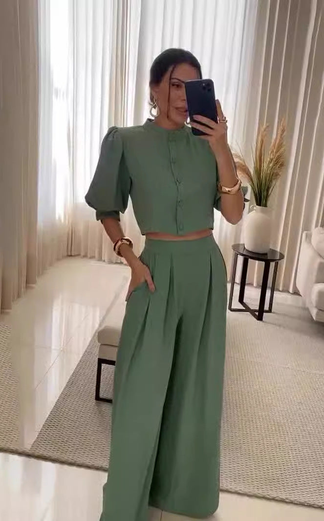 Woman in a green two-piece outfit from Summer Striped Half Sleeve Top Trousers Suit Women Clothing collection, showcasing elegant fashion style