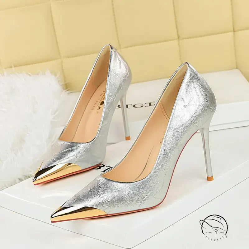 Silver metal pointed super high heel pumps with gold accents by Langry