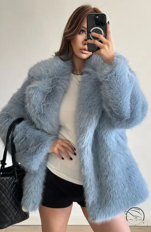 Light blue faux fur coat with quilted black handbag, Langry fashion