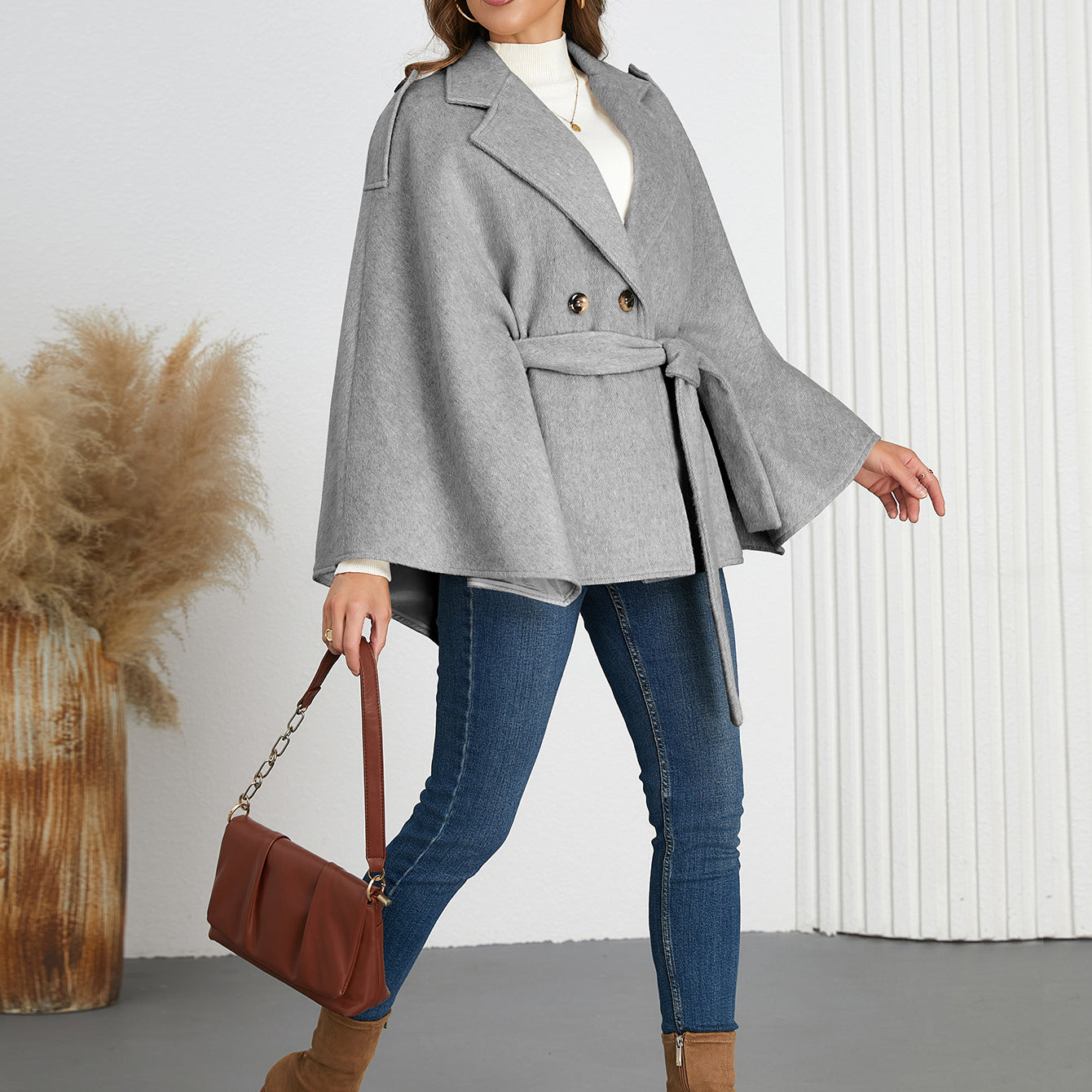 Woman in a gray belted cape coat from Langry, perfect for winter fashion ملابس