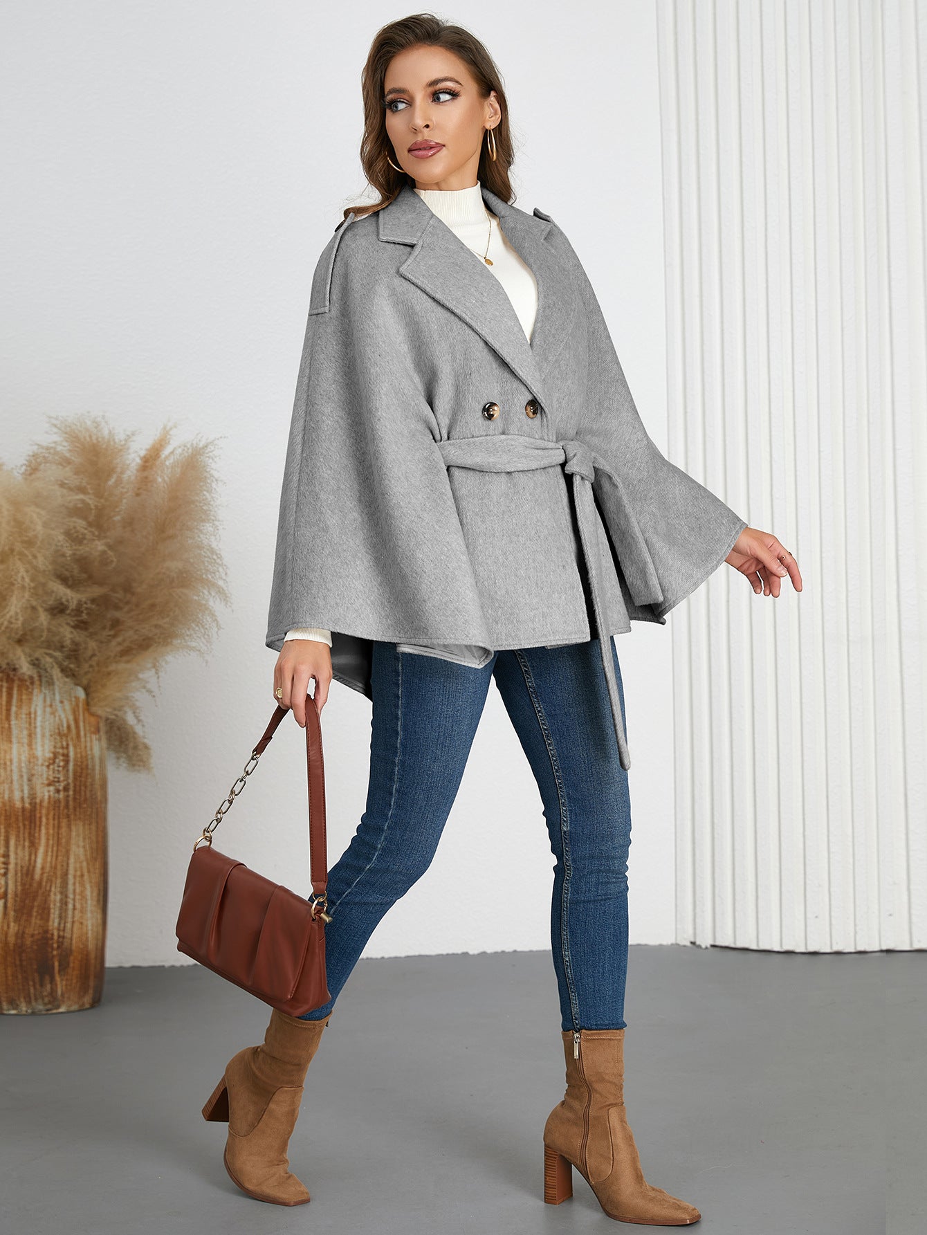 Woman in a gray belted cape coat from Langry, perfect for winter fashion ملابس