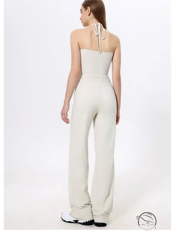 White halter-neck langry fashion jumpsuit with wide-leg quick-drying pants and sneakers