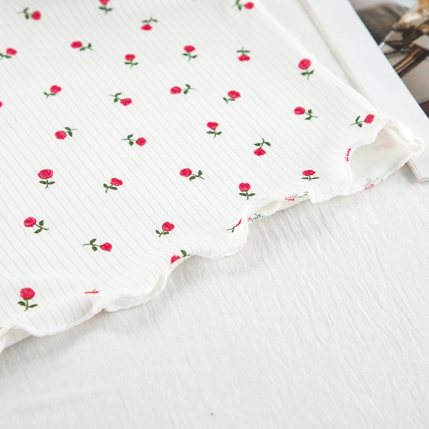 Elegant white fabric with red rose floral print and ruffled edge for casual fashion wear