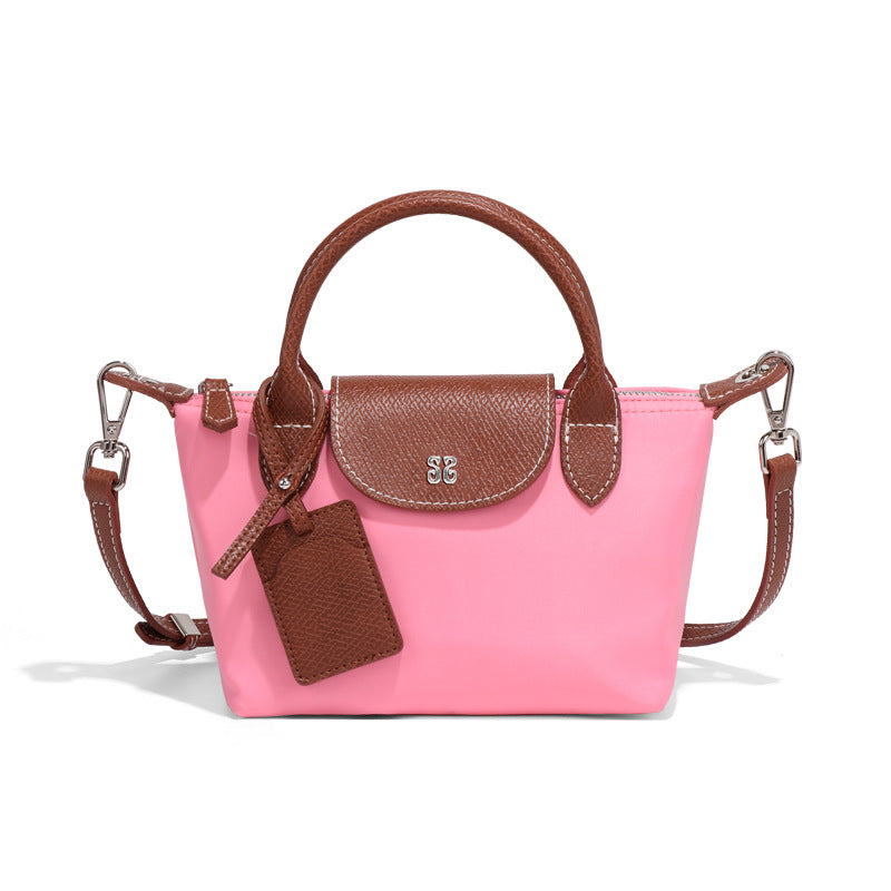 Pink nylon handbag with brown leather accents, a stylish Langry fashion accessory