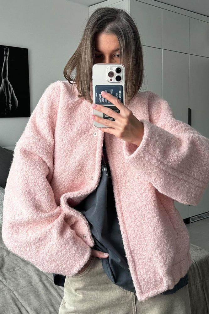 Pink short furry coat displayed with a pink bouclé jacket for fashionable winter wear