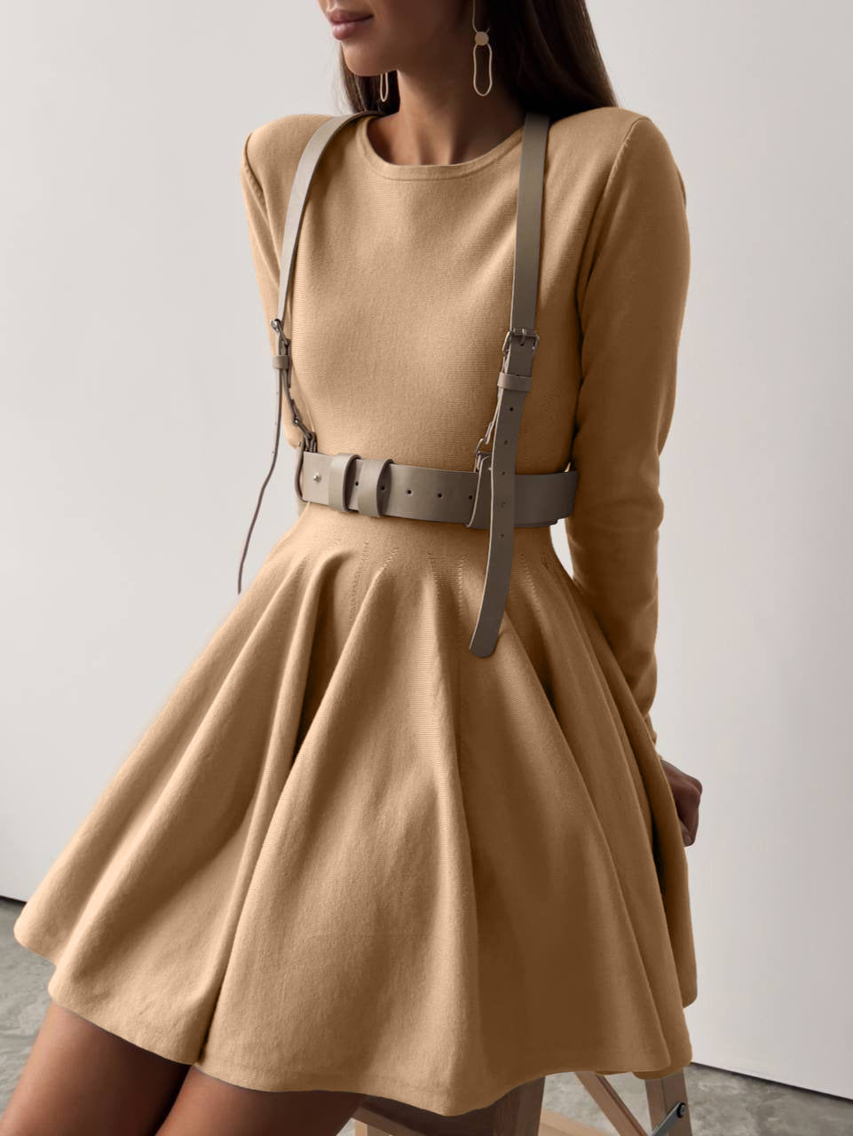 Beautiful woolen knitted dress featuring a tan long-sleeved design with harness belt