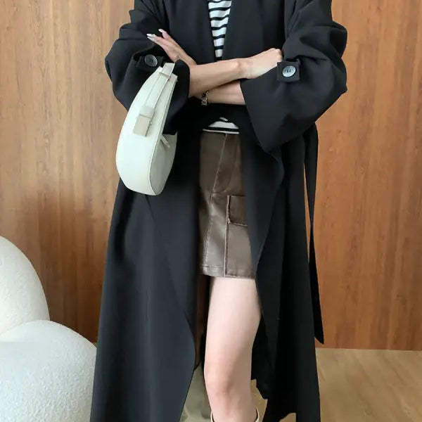 Elegant black trench coat in cozy long high-end fashion style