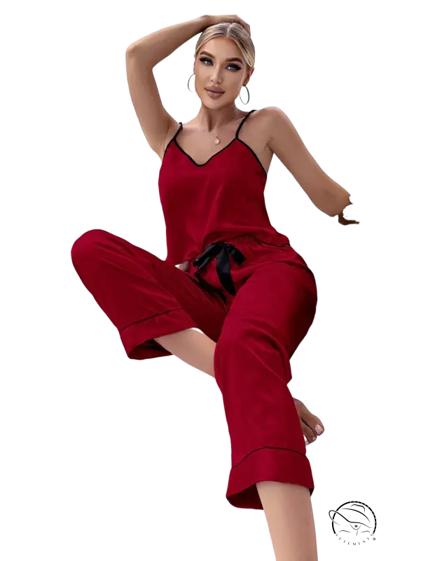 Red satin pajama set with black trim, tie belt and black eye mask