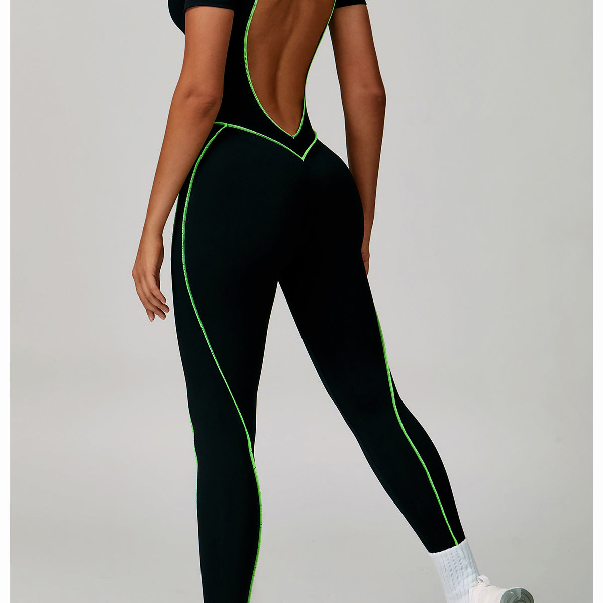 Langry black green open-back fashion jumpsuit with white socks and sneakers for yoga exercise