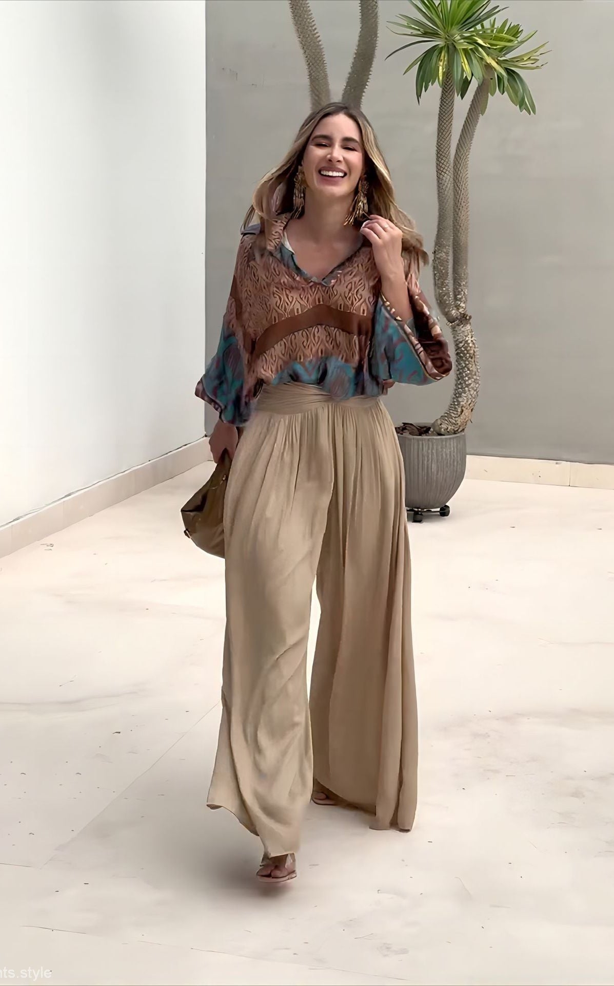 Elegant two piece set featuring a woman in flowing pants and patterned blouse with free shipping