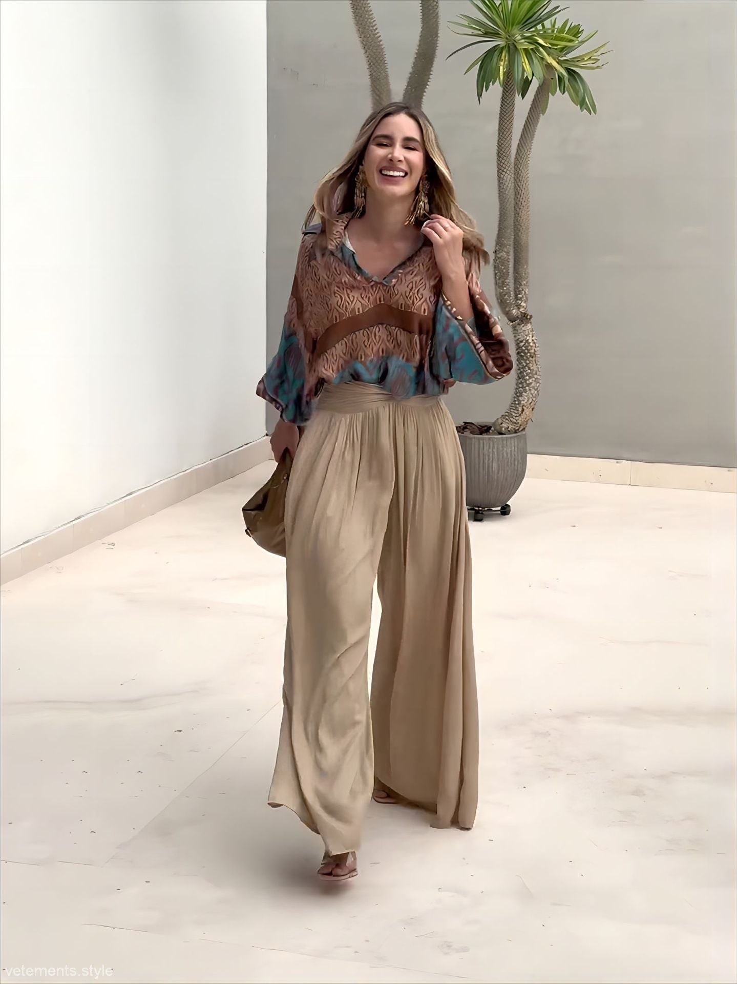 Elegant two piece set featuring a woman in flowing pants and patterned blouse with free shipping