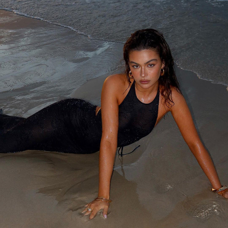 Woman in black mesh halter dress on beach wearing lace up mesh halter dress