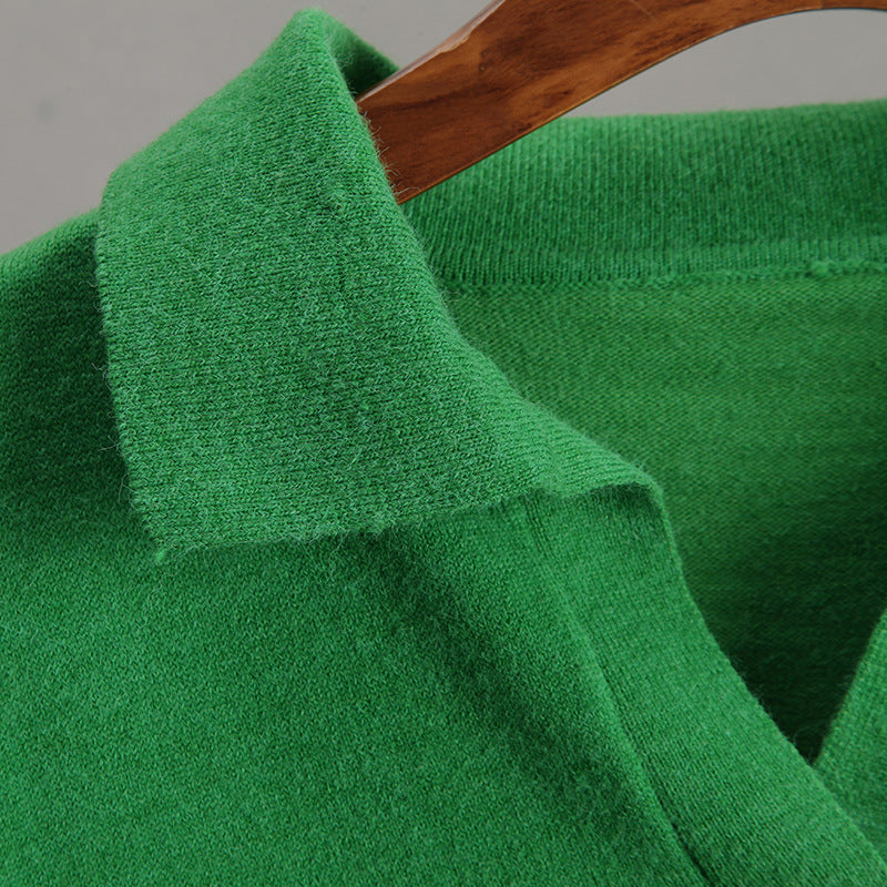 Close-up of vibrant green knitted sweater with polo collar showcasing fashionable ملابس craftsmanship