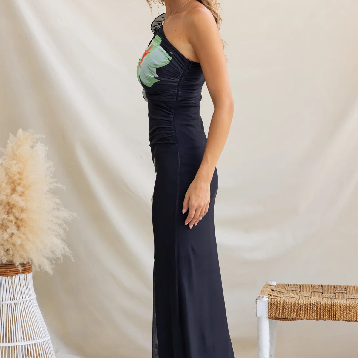 Woman in a black one-shoulder dress, showcasing elegant langry fashion ملابس style