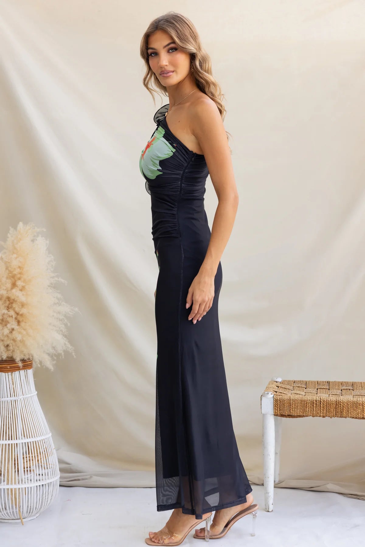 Woman in a black one-shoulder dress, showcasing elegant langry fashion ملابس style