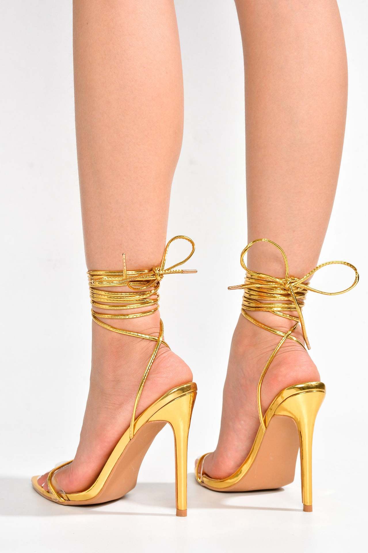 Elegant gold strappy high heels from Ankle Strap Stiletto Heels collection, perfect for fashion enthusiasts and ملابس accessorizing