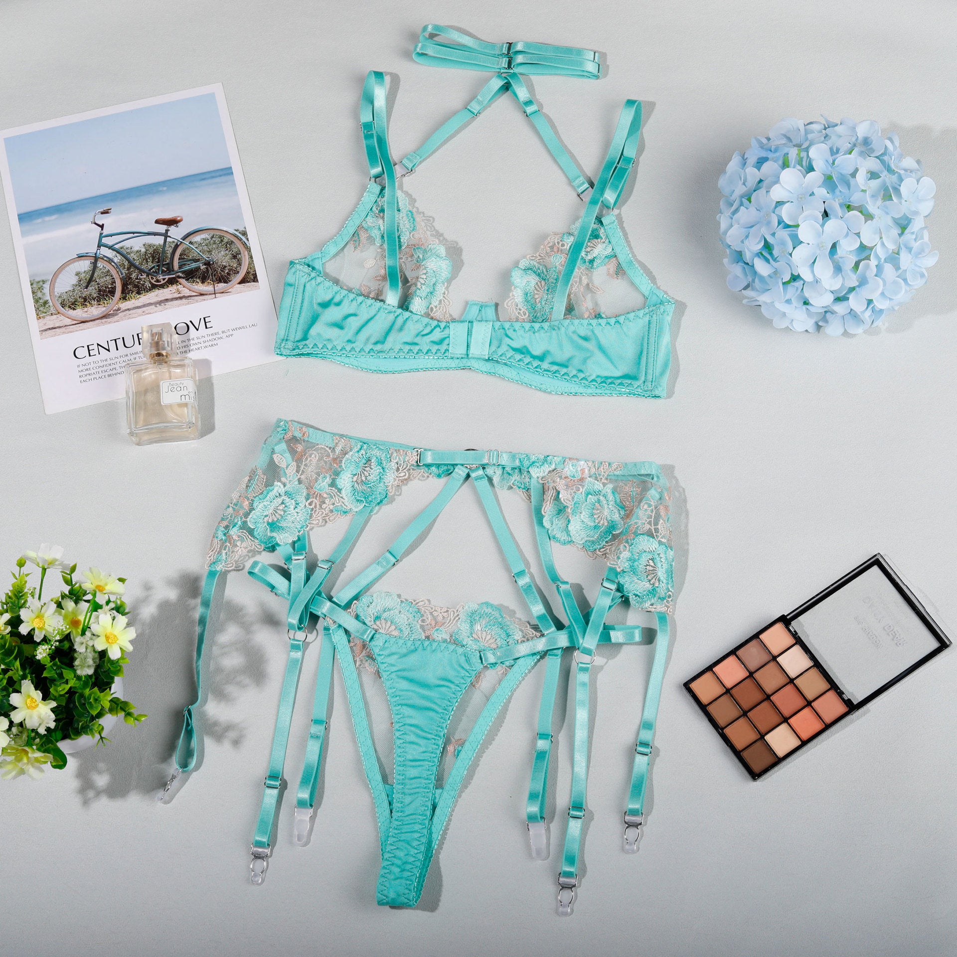 Mint green lingerie set with strappy details and garter attachments for elegant fashion ملابس