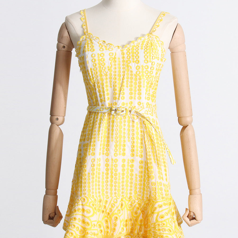 Yellow and white patterned sundress with spaghetti straps, ideal for summer fashion ملابس