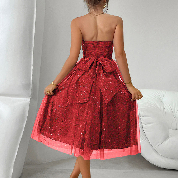 Strapless red tulle cocktail dress with bow at waist, perfect for elegant fashion events
