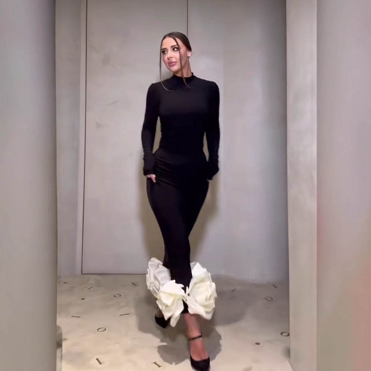 Elegant fishtail floral dress featuring a woman in black fashion attire with white accents