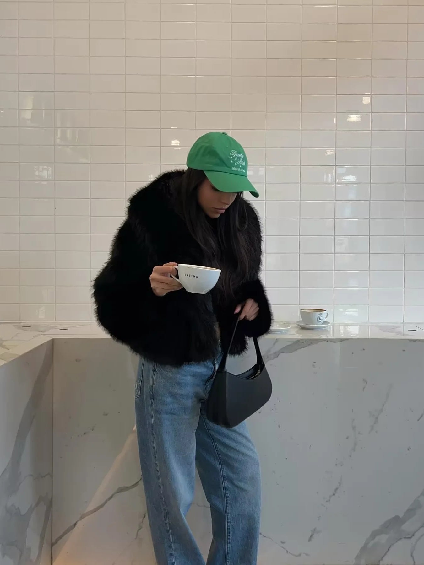 Langry faux fur fashion: green cap with logo, black strap, leather bag