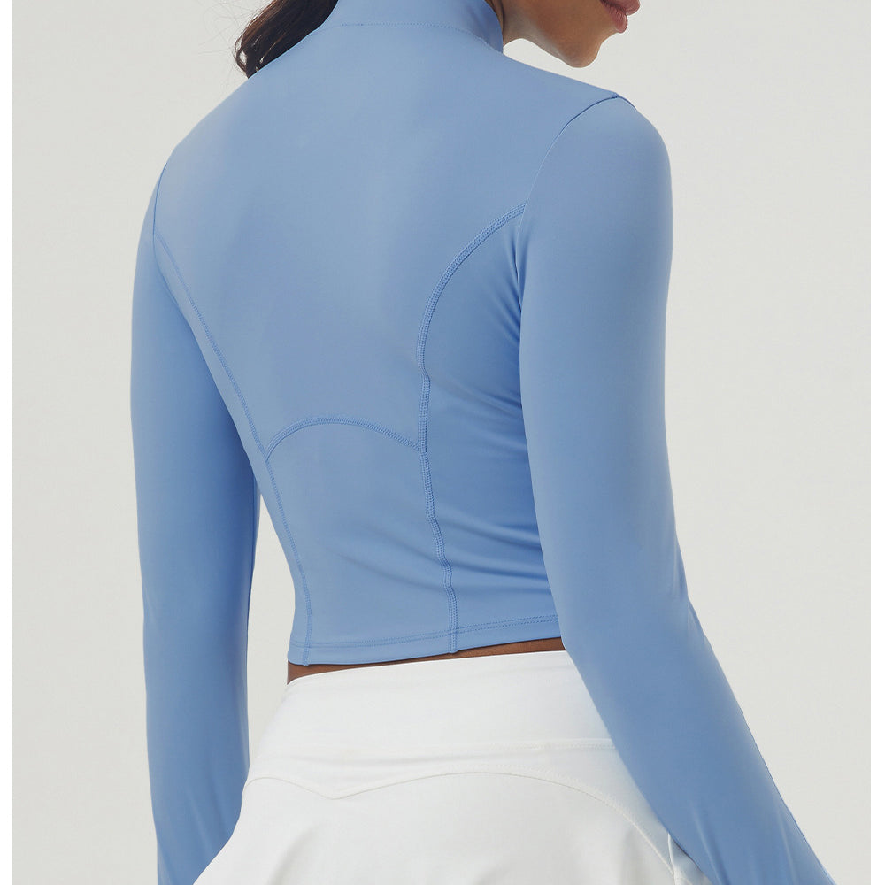 Periwinkle blue long sleeve athletic top with mock neck and sculpted seams for women