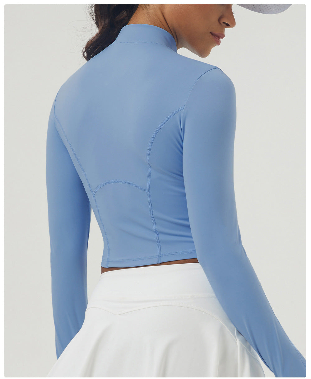 Periwinkle blue long sleeve athletic top with mock neck and sculpted seams for women