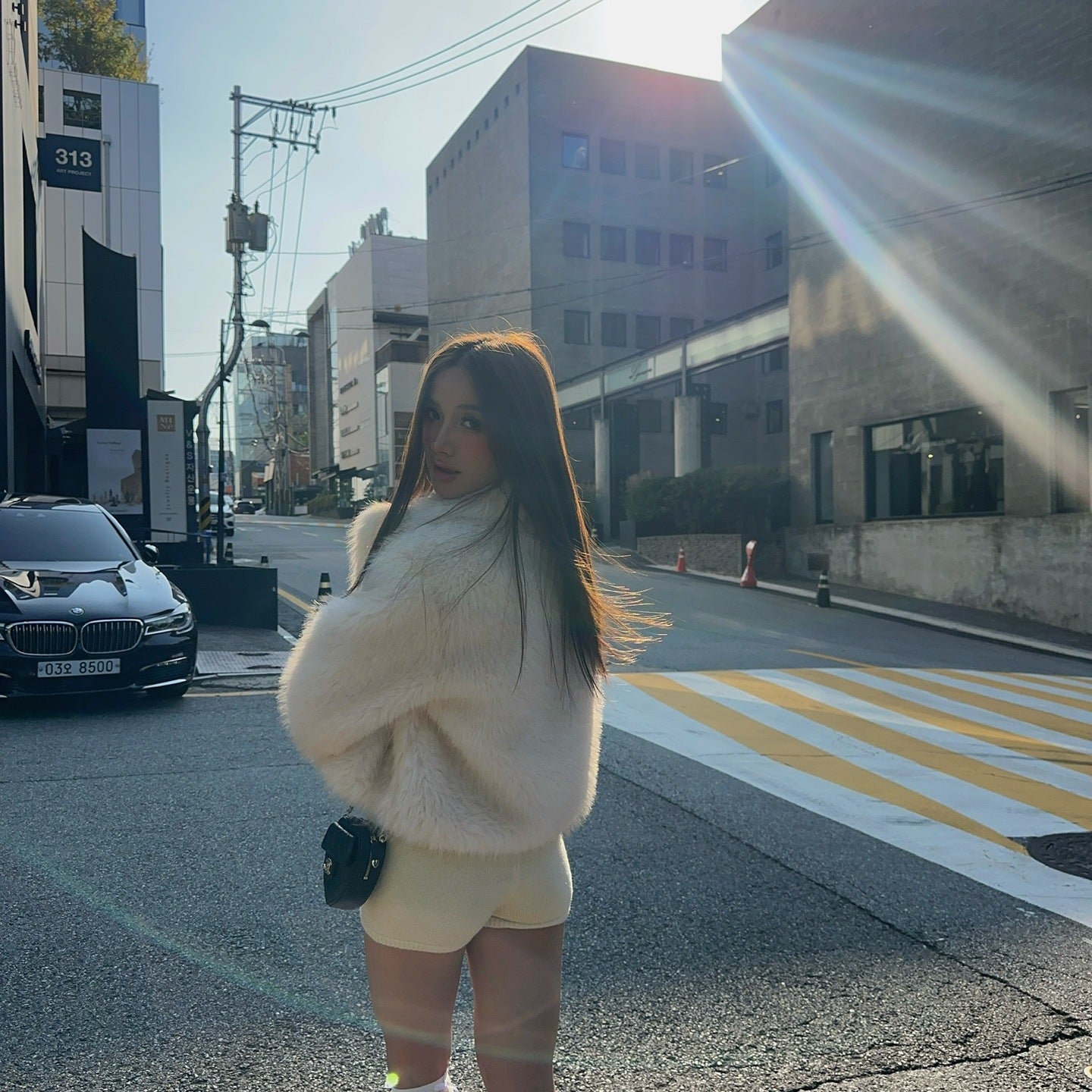 Short loose casual faux fur coat in cream with green boots and white socks