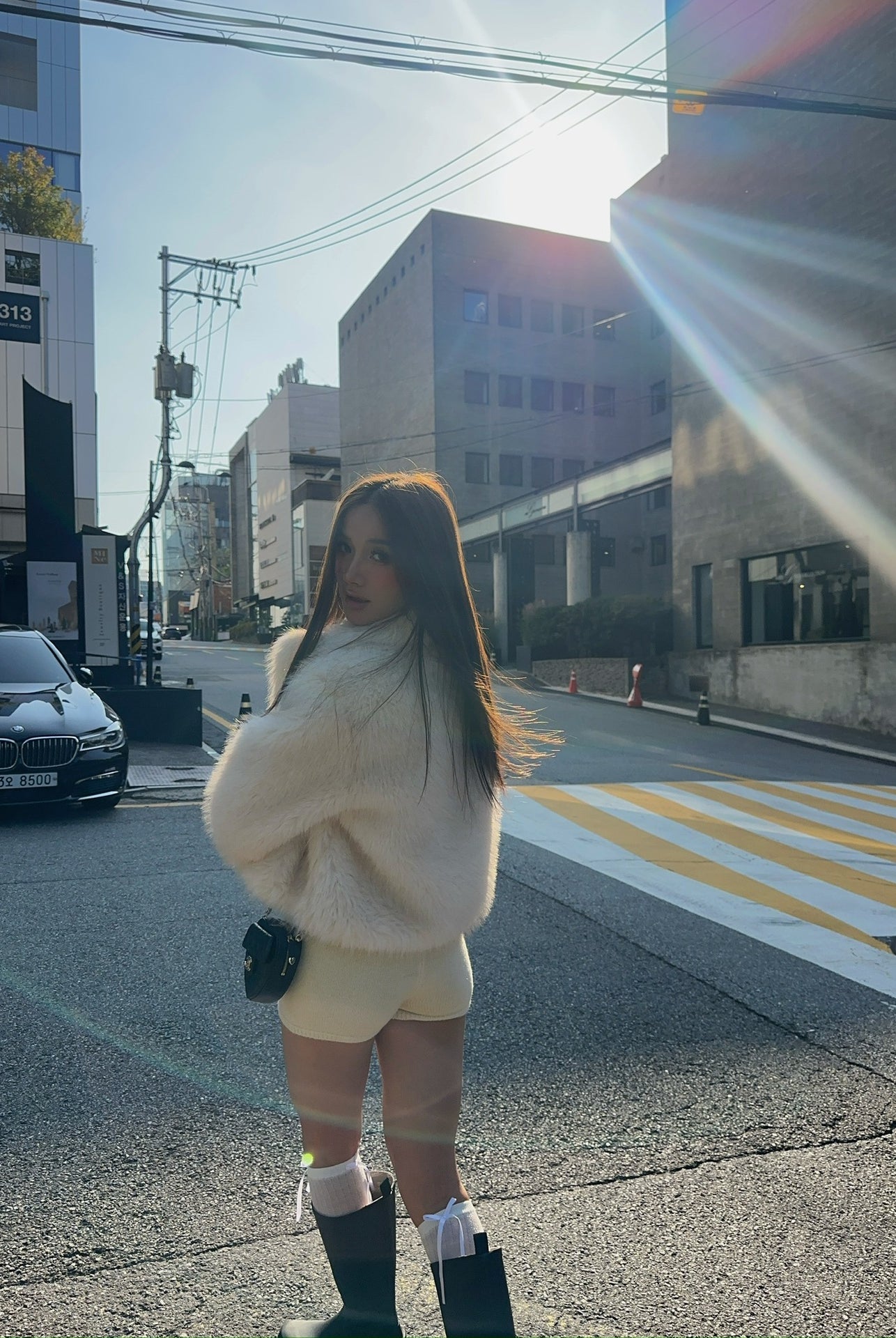 Short loose casual faux fur coat in cream with green boots and white socks