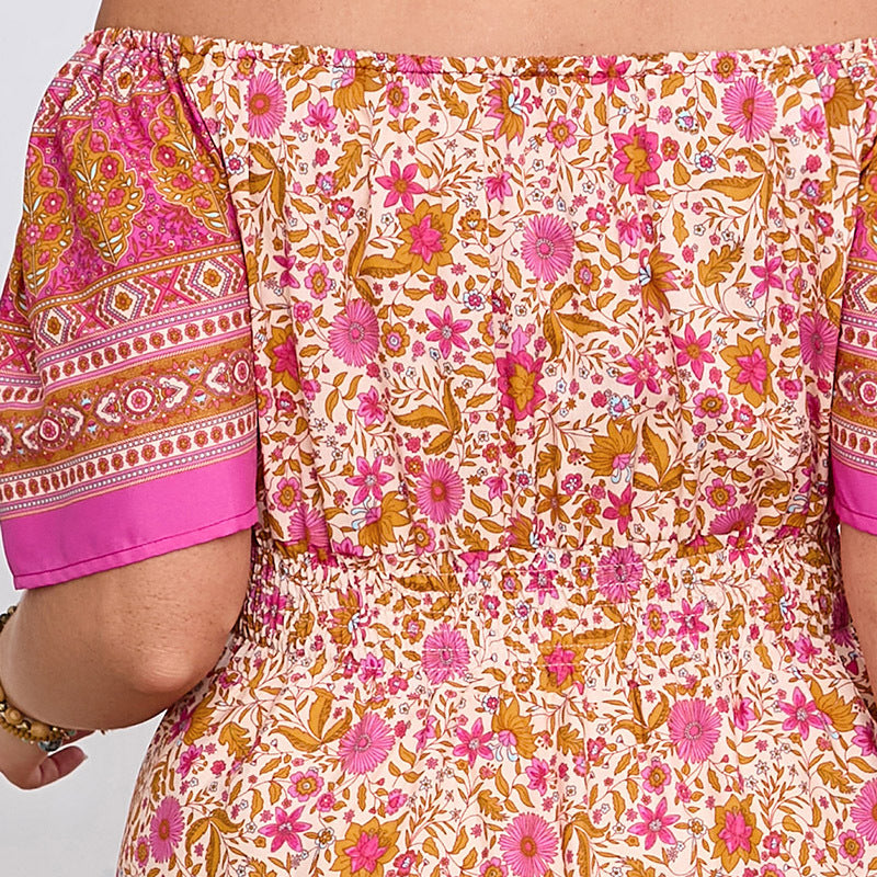 Elegant bohemian dress featuring floral off-the-shoulder design and patterned sleeves