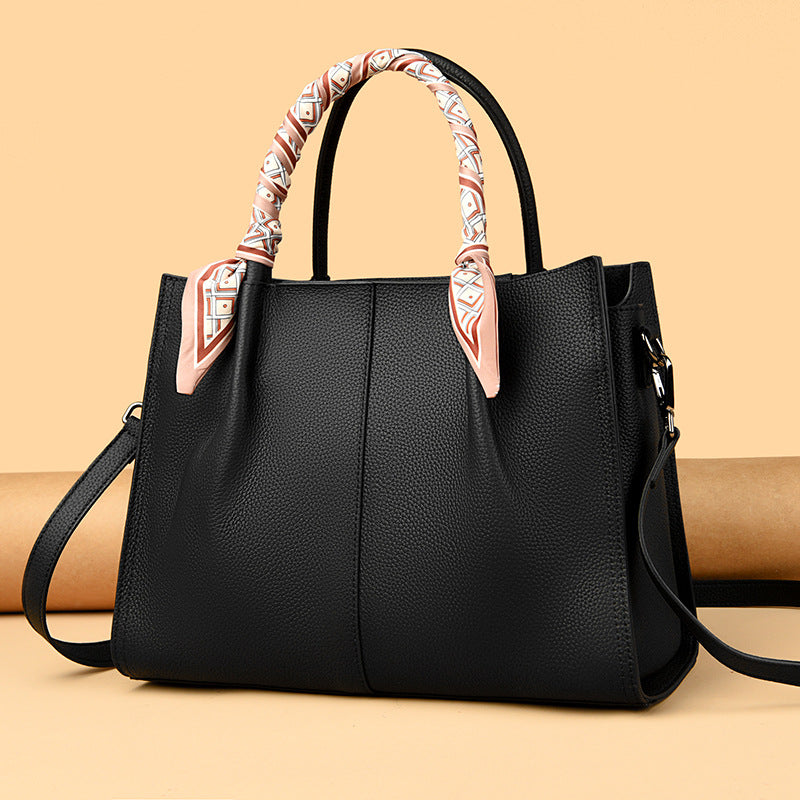 Elegant langry genuine leather handbag with black woven handles and silver hardware