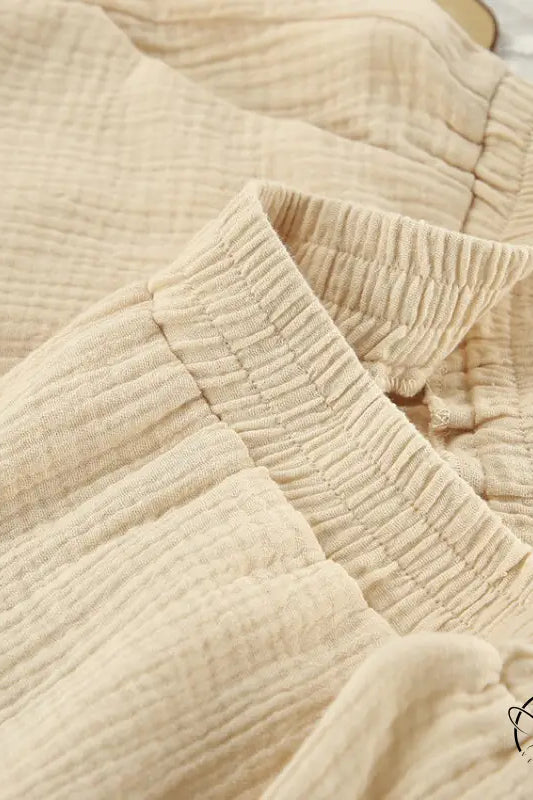 Close-up of beige crinkled winter pure cotton pajamas fabric with elastic waistbands