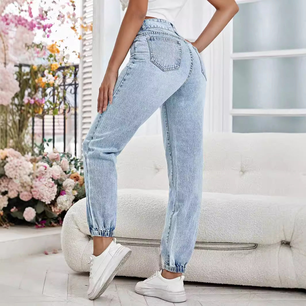 Light-wash blue drooping loose denim pants with elasticized ankles for a relaxed fit