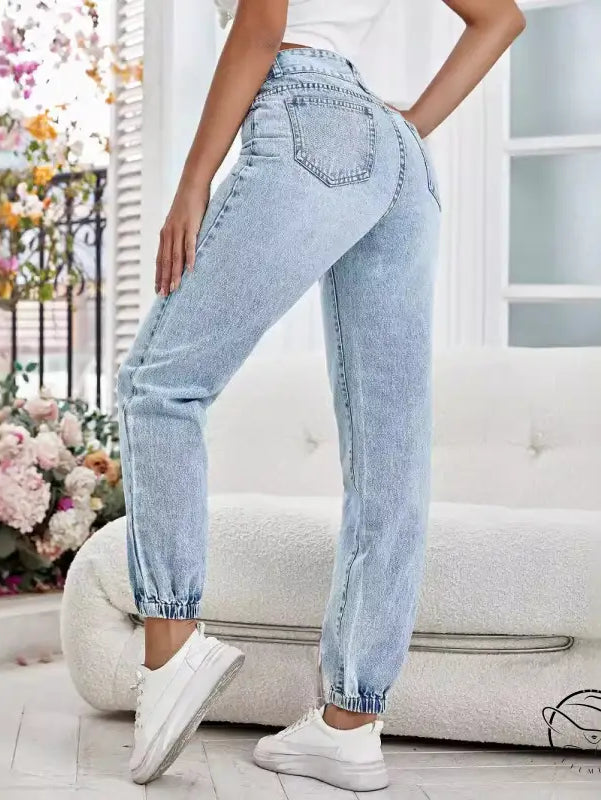 Light-wash blue drooping loose denim pants with elasticized ankles