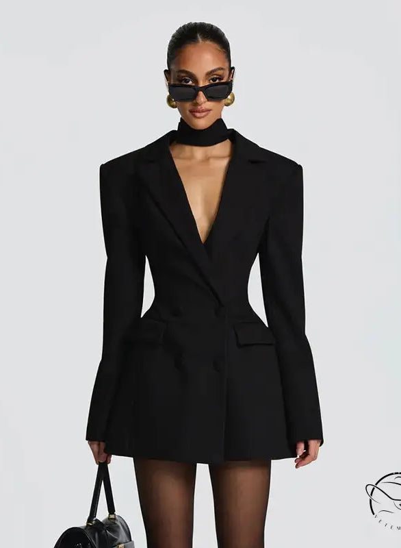 Black long sleeve blazer dress with exaggerated shoulders and deep v-neckline